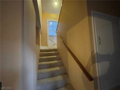 Back door. Stairs lead up to a private bedroom and
