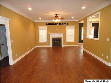 Family room has 10 foot ceilings, hardwood flooring, ceiling fan, gas logs in fireplace, recessed lighting.