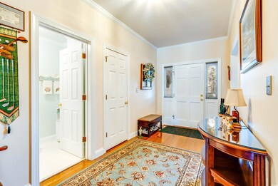 Foyer entrance featuring ornamental molding and ha