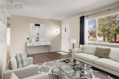 Virtually staged Living room featuring baseboards 