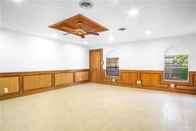 Empty room with wainscoting, recessed lighting, and ceiling fan