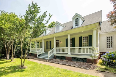 Louisiana style home featuring a porch, a shingled roof, and a front yard