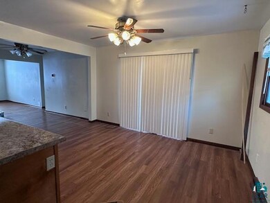 Unfurnished living room featuring ceiling fan and 
