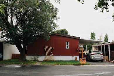 View of side of home featuring an attached carport