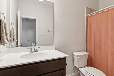 Full bathroom featuring curtained shower, a textur