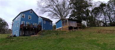 Back of property with a deck, board and batten sid