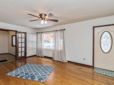 Family room with gorgeous hardwood floors and larg