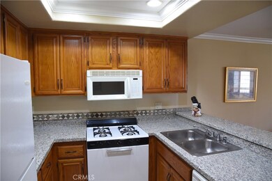 Old fluorescent lighting has been replaced with modern recessed lights in a coved niche with pretty added mouldings!