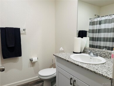 Bathroom with wood-type flooring, large vanity, an