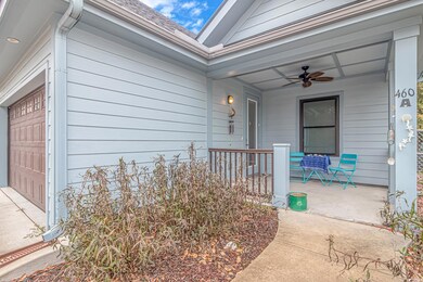 Doorway to property featuring a porch, a ceiling f