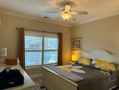 Bedroom featuring ceiling fan, wood-type flooring,