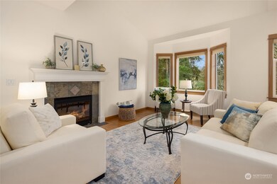 Spacious great room features vaulted ceiling and looks out to the lush greenbelt.