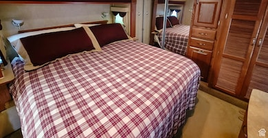 Carpeted bedroom with a closet