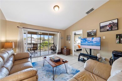 Living room with light tile patterned flooring, baseboards, and high vaulted ceiling