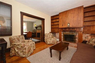 The living room has hardwood flooring and a log bu
