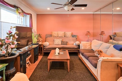 Living room with ceiling fan, wood-type flooring, 