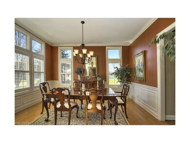 Hardwood flooring in a spacious dining room with w