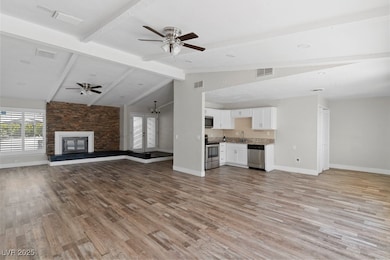 Unfurnished living room with ceiling fan, baseboar