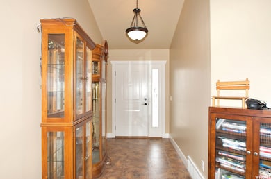 Foyer featuring baseboards and french doors
