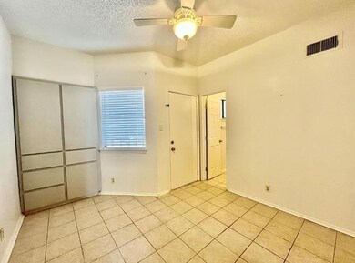 Unfurnished room featuring light tile patterned f