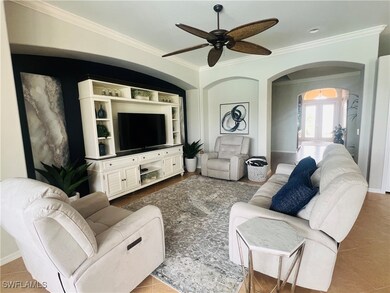 Tiled living room with ceiling fan and ornamental