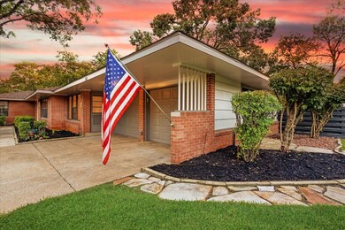 View of front of property with brick siding, an attached garage, and driveway