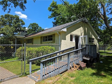 Ranch-style home featuring a front lawn