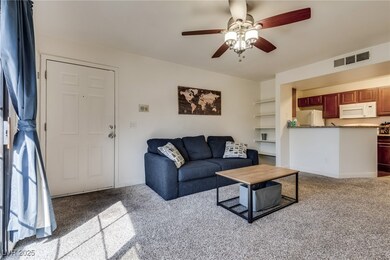 Carpeted living room featuring baseboards, visible