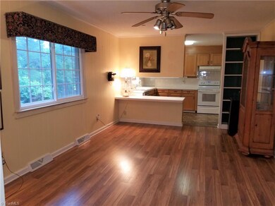 Family/Dining room combo is a cozy space. Laminate flooring.