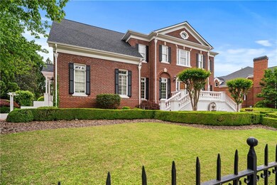 View of front of house with brick siding and a front lawn