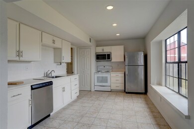 Kitchen featuring backsplash, light tile floors, a