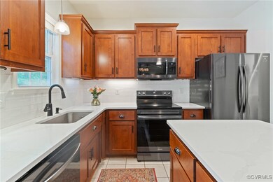 Kitchen featuring stainless steel appliances, a si