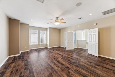 Grand double doors welcome you into the spacious primary bedroom.