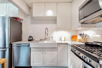 Kitchen featuring backsplash, stainless steel app