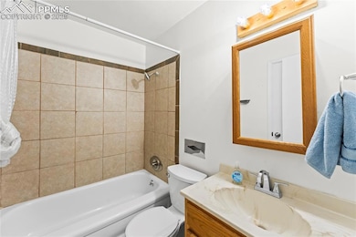 Bathroom featuring shower / bath combo and vanity