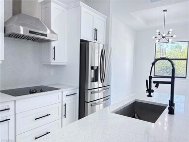 Kitchen with stainless steel refrigerator with ice