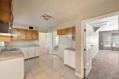 Kitchen with sink, cooling unit, and light colored