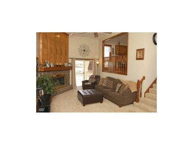 Cozy brick fireplace, and sliding glass door leadi