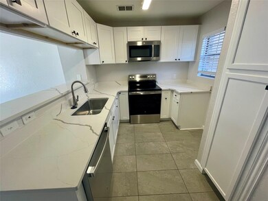 Kitchen with appliances with stainless steel finis