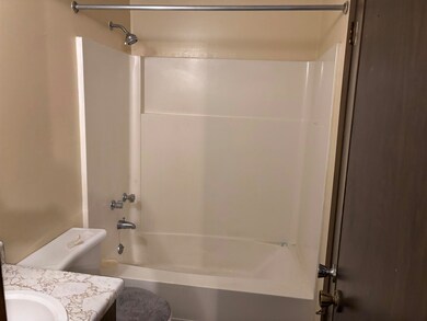 Bathroom featuring shower / bathtub combination, t