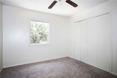 Unfurnished bedroom featuring carpet, a closet, ba