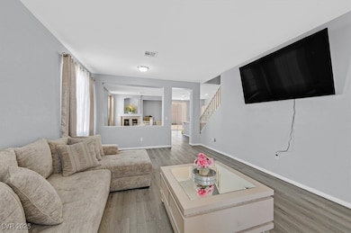Living area featuring light wood-style floors and stairs