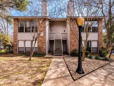 Split foyer home featuring stairs, brick siding, 