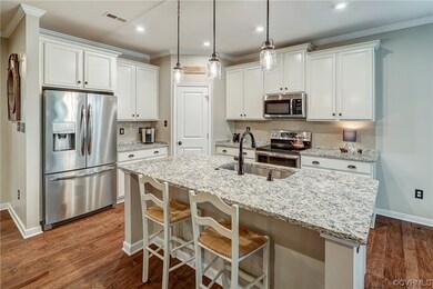 Kitchen featuring a kitchen island, white cabinetr