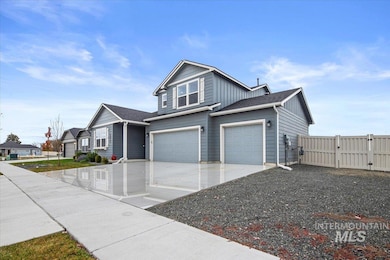 View of front of property with board and batten siding, concrete driveway, a garage, a gate, and roof with shingles