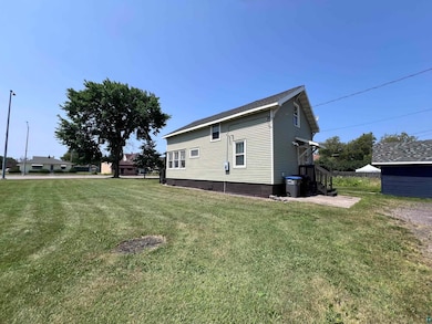 View of side of property featuring a lawn