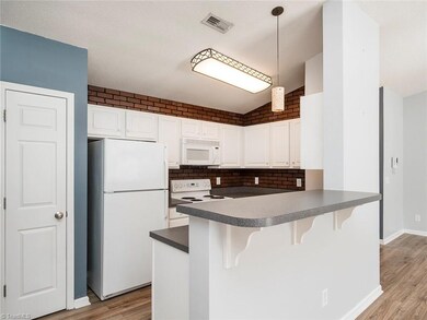 Kitchen with pantry, bar seating and great storage.