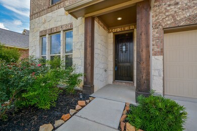 Inviting entry with wood beams and rich wood door