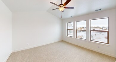 Unfurnished room with lofted ceiling, light colored carpet, and ceiling fan