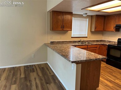 Kitchen with sink, black range with electric cookt